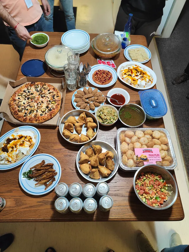 Friends gathered around a table full of food.